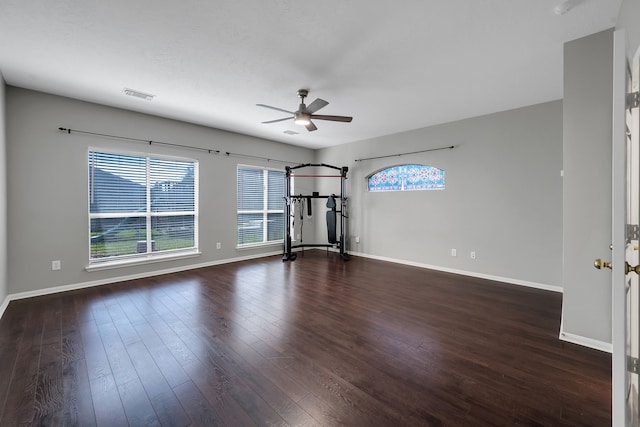 unfurnished room featuring dark wood finished floors, baseboards, and visible vents