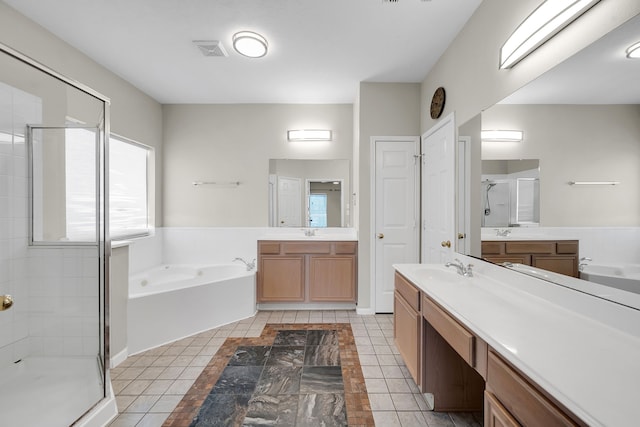 full bathroom featuring visible vents, two vanities, a sink, a shower stall, and a bath