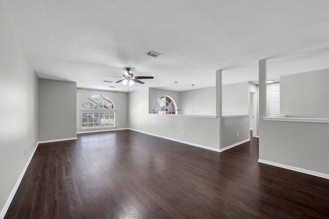 spare room with visible vents, baseboards, a ceiling fan, and hardwood / wood-style flooring