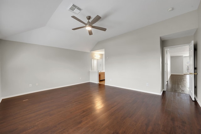 spare room featuring visible vents, dark wood-type flooring, ceiling fan, and vaulted ceiling