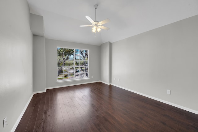 unfurnished room with baseboards, ceiling fan, dark wood-style flooring, and vaulted ceiling