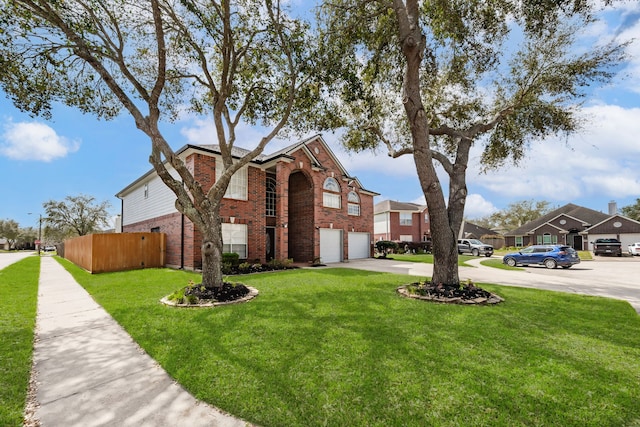 view of front of property with fence, concrete driveway, a front yard, a garage, and brick siding