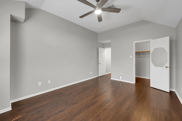 unfurnished bedroom with vaulted ceiling, baseboards, and dark wood-style flooring