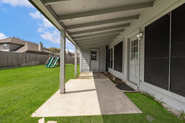 view of patio with a playground and a fenced backyard