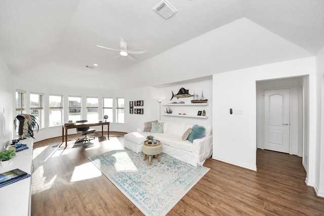 living area with visible vents, baseboards, ceiling fan, vaulted ceiling, and wood finished floors