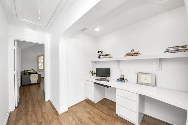 home office with baseboards, light wood-style flooring, and built in desk