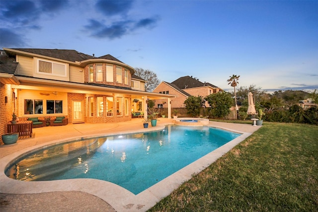 view of swimming pool featuring a patio area, an outdoor living space, a lawn, and a pool with connected hot tub