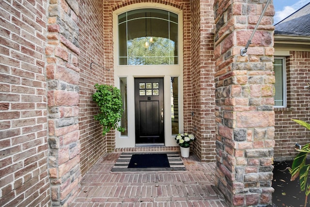 doorway to property with brick siding