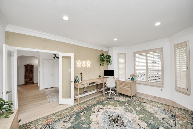 office space featuring recessed lighting, arched walkways, wood finished floors, and crown molding