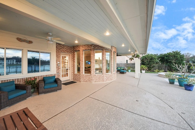 view of patio with ceiling fan and fence