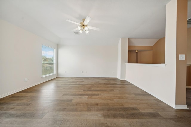 empty room with visible vents, baseboards, wood finished floors, and a ceiling fan