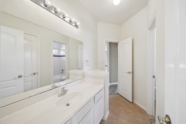 bathroom featuring vanity, tile patterned floors, a bath, and baseboards