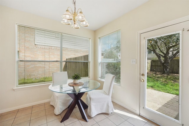 dining room with light tile patterned flooring, a notable chandelier, and a healthy amount of sunlight