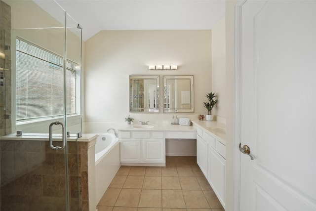 bathroom with vanity, lofted ceiling, tile patterned flooring, a shower stall, and a bath