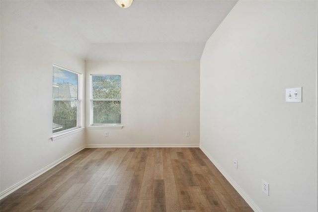 empty room with baseboards and wood finished floors