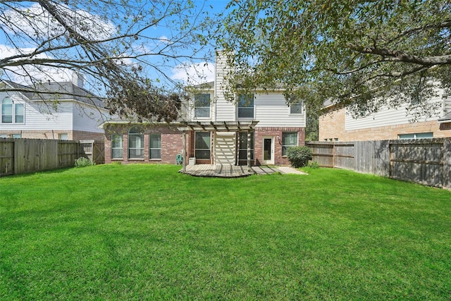 rear view of house with a yard, brick siding, a fenced backyard, and a pergola