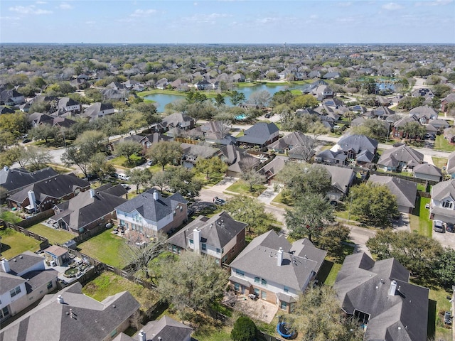 drone / aerial view with a residential view and a water view