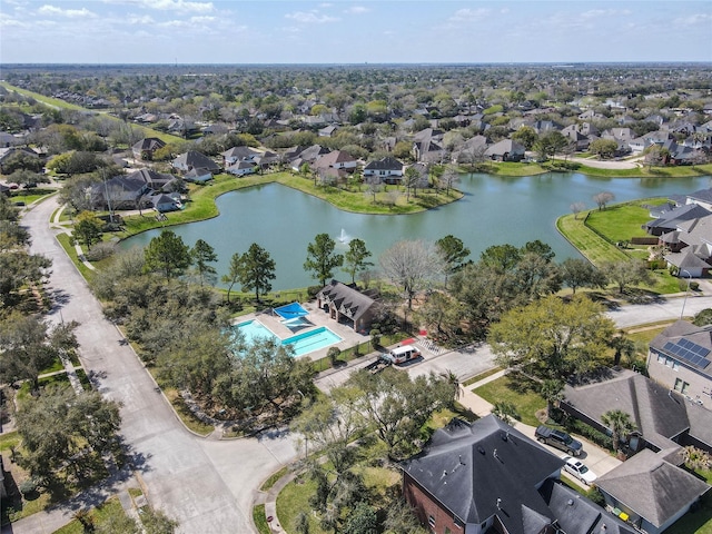 drone / aerial view with a residential view and a water view