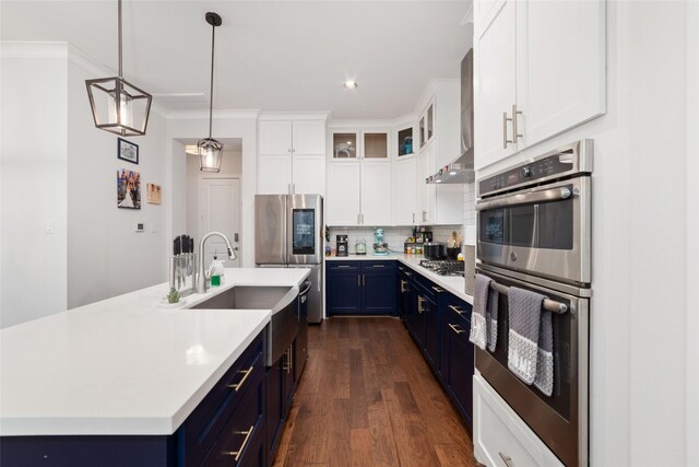 1239 W 23rd St Unit A, Houston, TX 77008 - kitchen with blue cabinetry, stainless steel appliances, light countertops, a sink, and recessed lighting