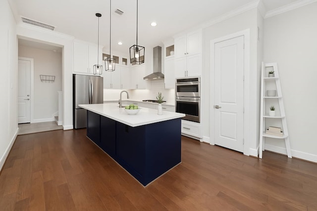 1239 W 23rd St Unit A, Houston, TX 77008 - kitchen featuring wall chimney exhaust hood, stainless steel appliances, light countertops, dark wood-type flooring, and white cabinetry