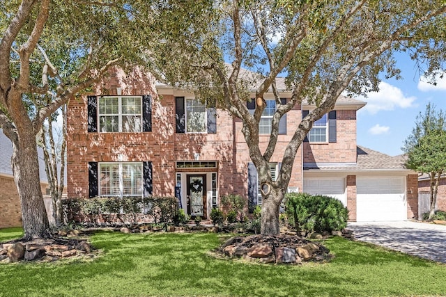 colonial house featuring a front lawn, brick siding, driveway, and a shingled roof