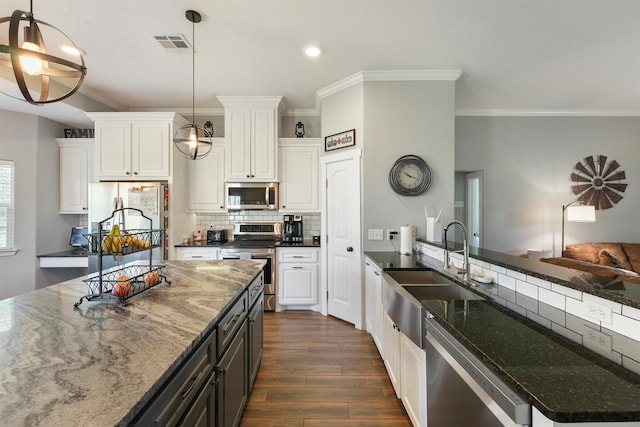 kitchen featuring stainless steel appliances, visible vents, white cabinets, and dark wood-style flooring