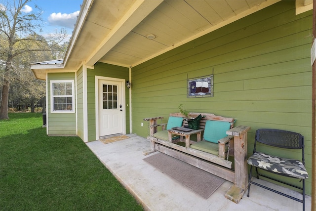 doorway to property with a yard and metal roof