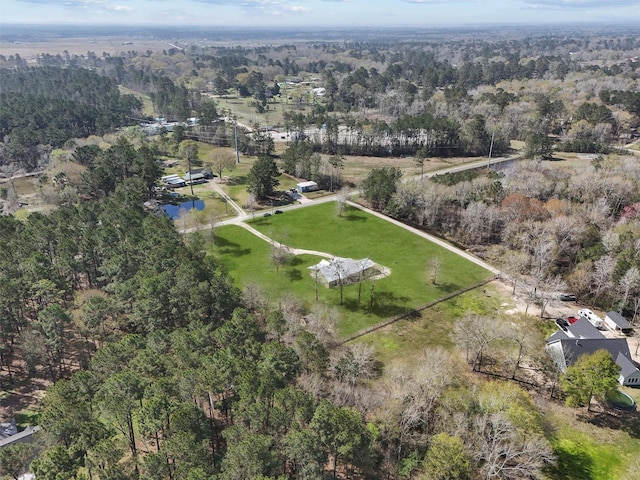 birds eye view of property with a view of trees