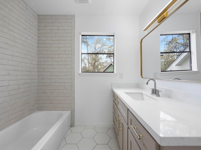 bathroom with baseboards, vanity, and tile patterned flooring