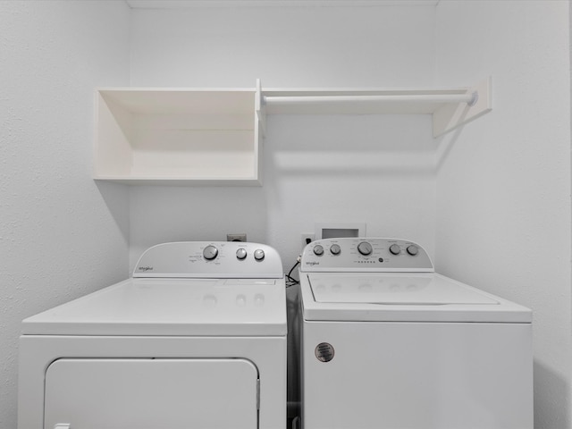 washroom featuring separate washer and dryer and laundry area