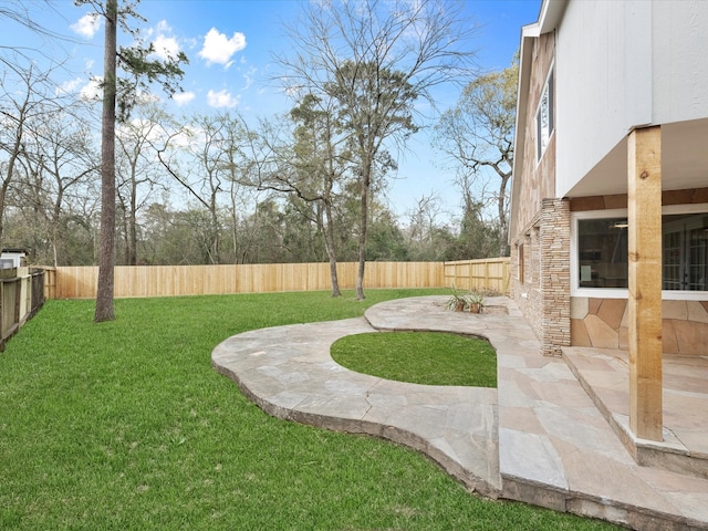 view of yard featuring a patio area and a fenced backyard