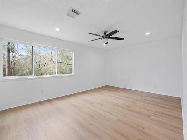 empty room featuring light wood finished floors, visible vents, baseboards, recessed lighting, and a ceiling fan