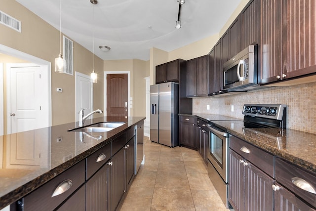 kitchen with visible vents, appliances with stainless steel finishes, decorative backsplash, and a sink