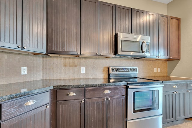 kitchen with backsplash, stainless steel appliances, and dark stone counters