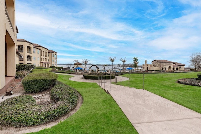 view of community with a yard and a patio area