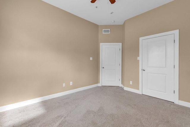 unfurnished bedroom with visible vents, baseboards, carpet, and a ceiling fan