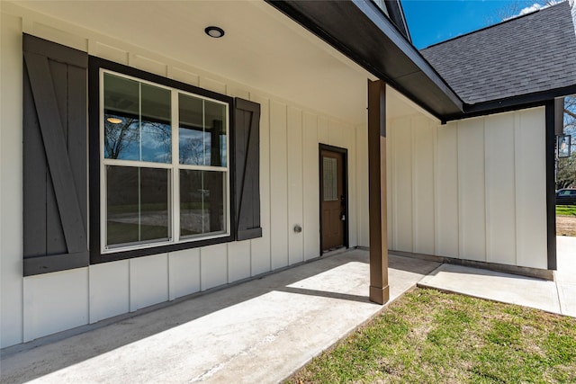 property entrance featuring board and batten siding and roof with shingles