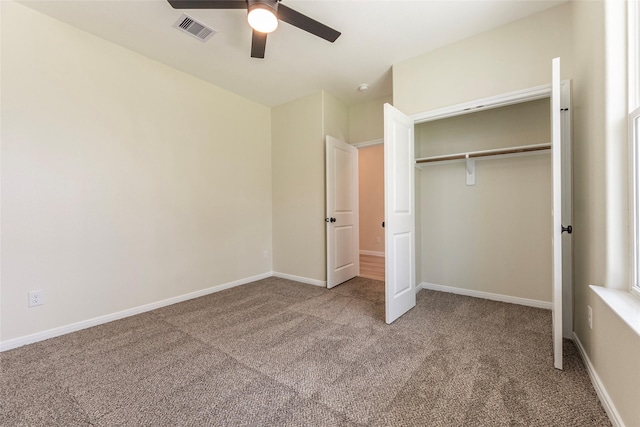 unfurnished bedroom featuring visible vents, baseboards, carpet, and a closet