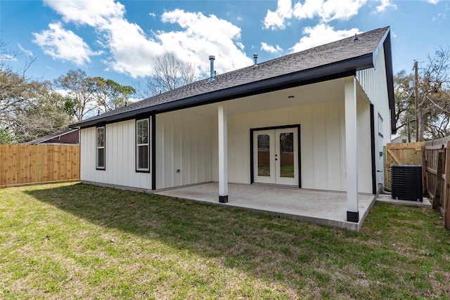 rear view of property with a patio, central AC unit, a fenced backyard, french doors, and a lawn