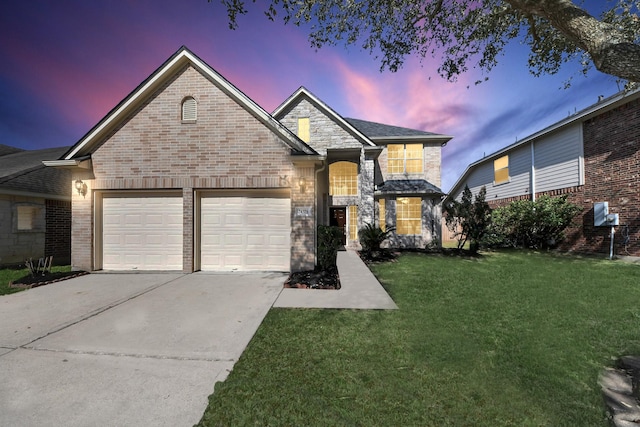 traditional home with brick siding, a garage, concrete driveway, and a front lawn