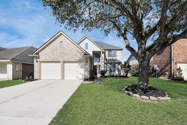 traditional home with a garage, brick siding, concrete driveway, and a front yard