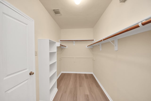 spacious closet with visible vents and light wood-style flooring