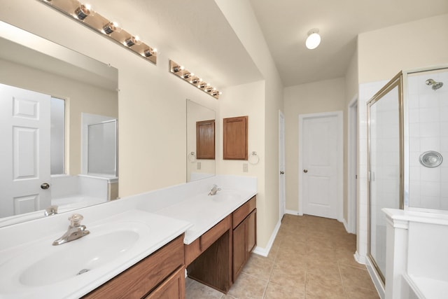 bathroom featuring tile patterned flooring, double vanity, a stall shower, and a sink