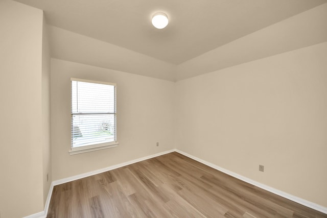 spare room with wood finished floors and baseboards