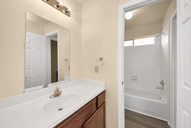 full bathroom featuring vanity, wood finished floors, and shower / washtub combination