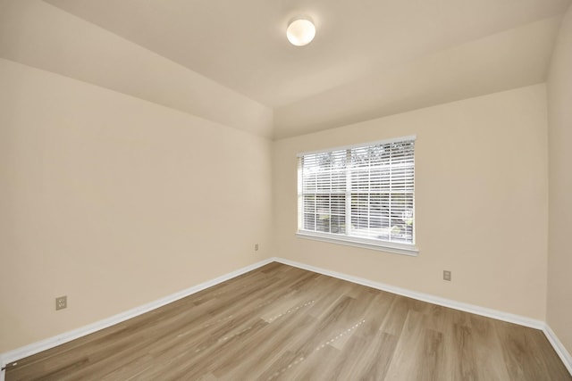 unfurnished room featuring baseboards and wood finished floors