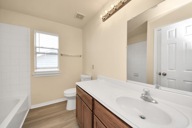 full bathroom with vanity, wood finished floors, visible vents, baseboards, and toilet