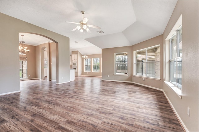 unfurnished living room featuring dark wood finished floors, ceiling fan with notable chandelier, visible vents, and baseboards