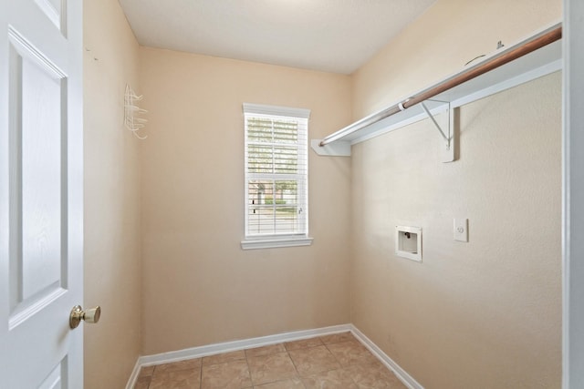 washroom featuring light tile patterned floors, laundry area, baseboards, and washer hookup