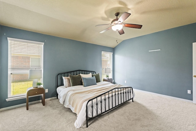 bedroom with carpet flooring, lofted ceiling, and baseboards